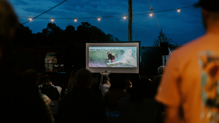 People watching surf film at outdoor screening