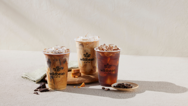 Three iced coffees in takeaway cups