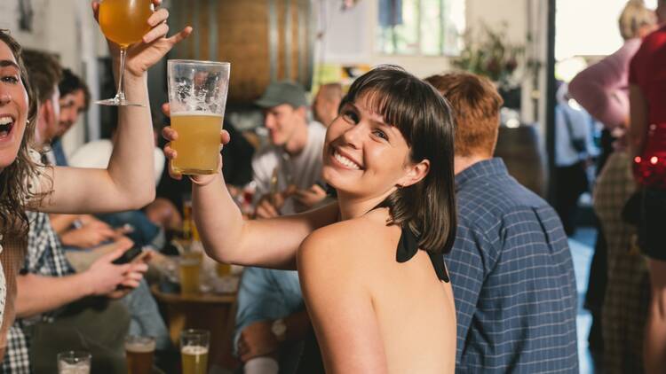 Woman smiling with a pint of beer.