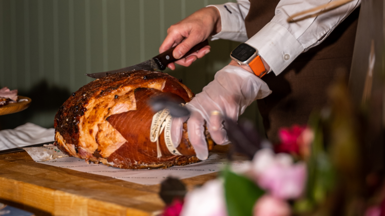 Butcher slicing Christmas ham