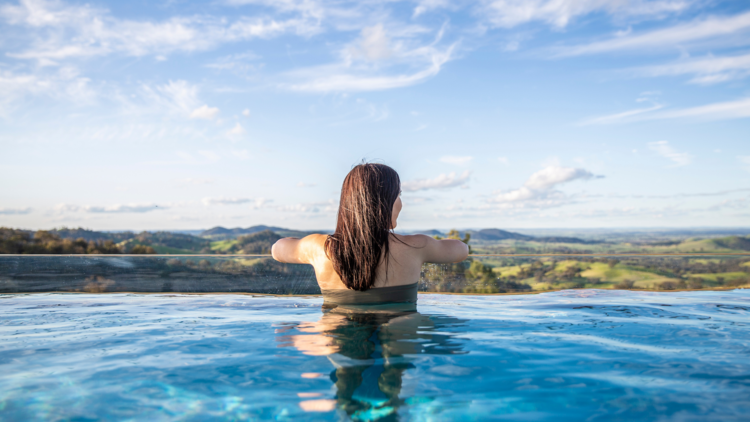 woman overlooking the valley from sierra escape infinity pool