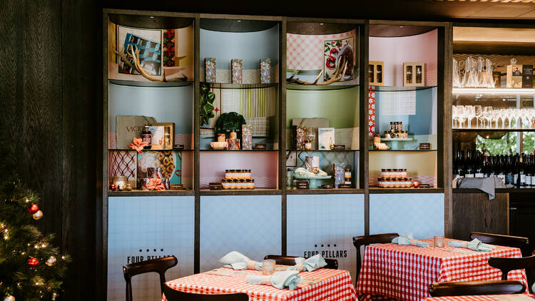 Festive pop-up store with red and white checkered cloth-covered tables. 