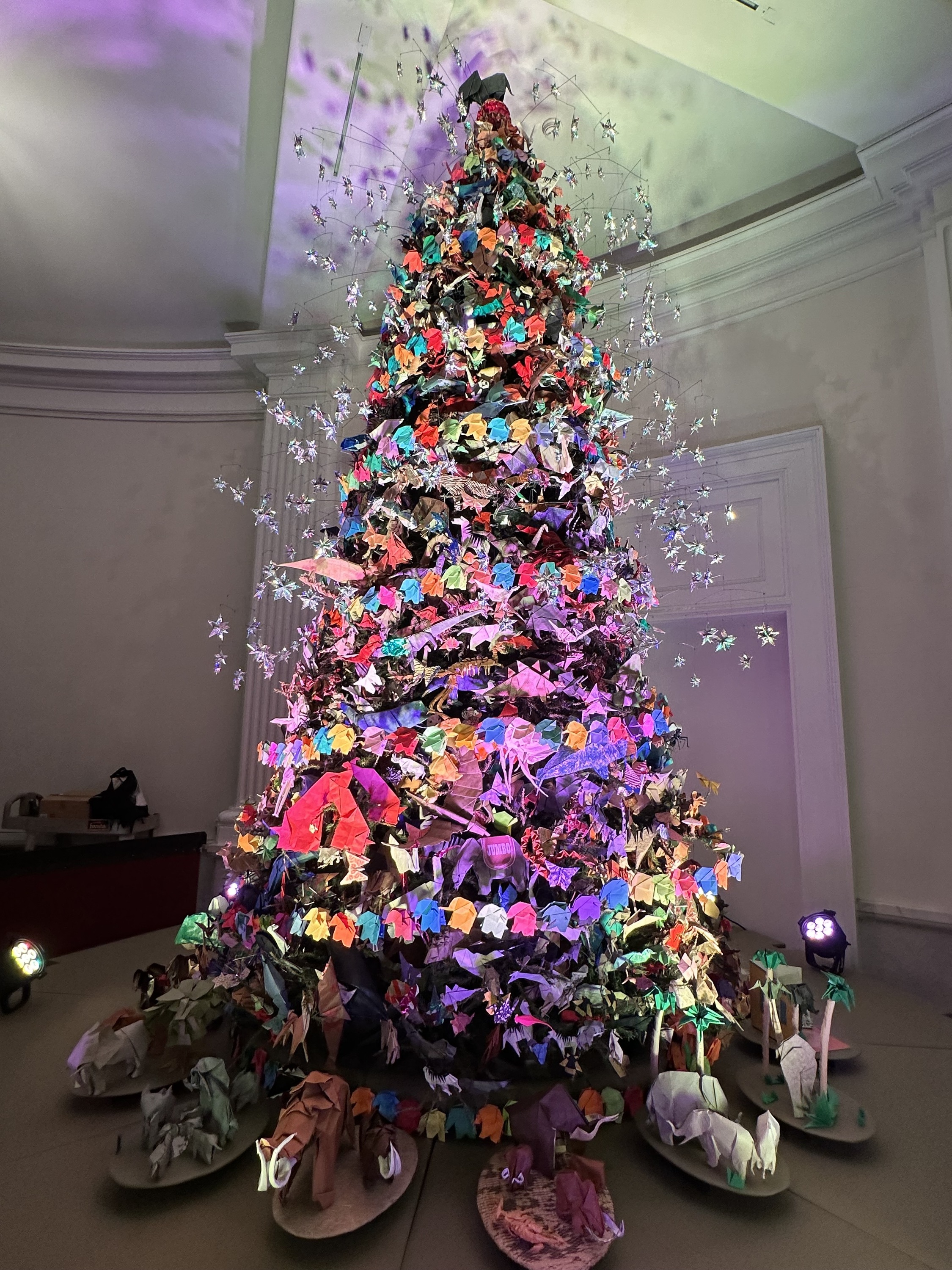 A Christmas tree decorated with origami ornaments.