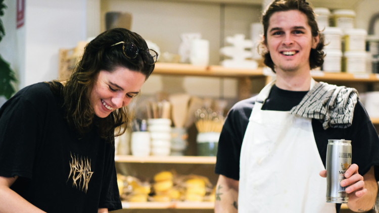 Two people smiling at a clay studio