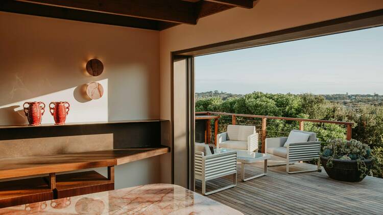 A deck with a view of a green landscape. 