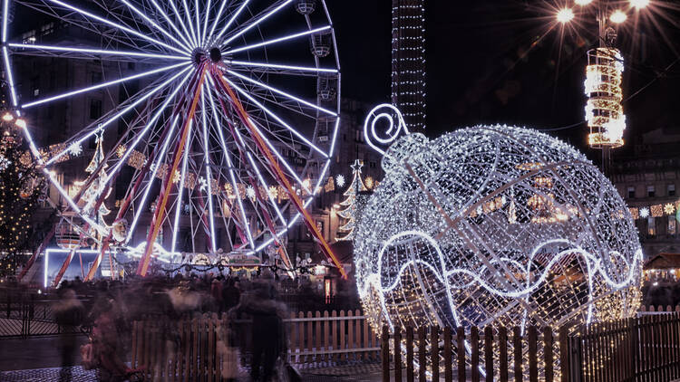 Christmas decorations and big wheel at night in George Square, Glasgow