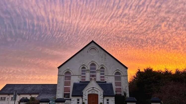 A church with a sunset  (Photograph: Sunset Bay )