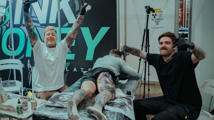 Tattoo artists posing for a photo. 
