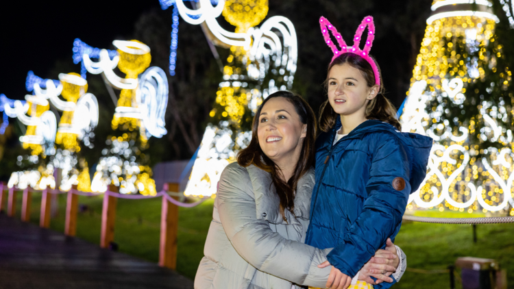 A mother and daughter look at Christmas lights