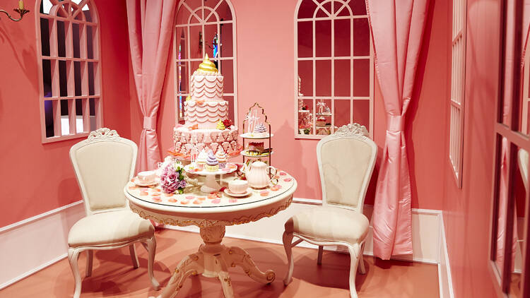 A table with a pink, poop-themed array of treats. 