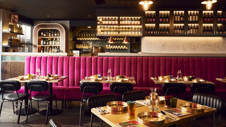 A dining room with a pink velvet banquet