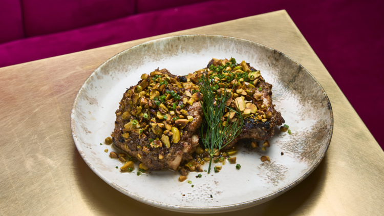 Meat with garnishes on a white plate