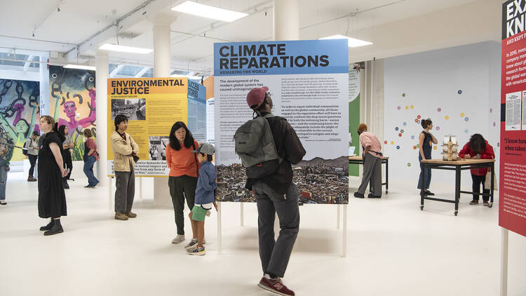 People look at posters inside the Climate Museum.