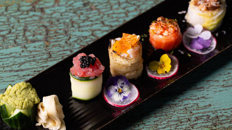 A dish of colourfully garnished sushi.