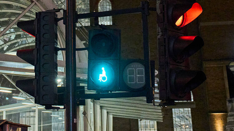 Wheelchair user crossing point light, Liverpool Street, London