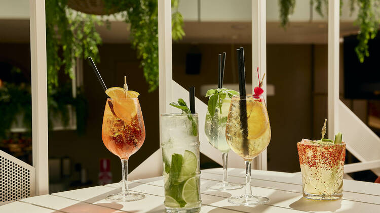 An assortment of Spritz cocktails on an outdoor table.