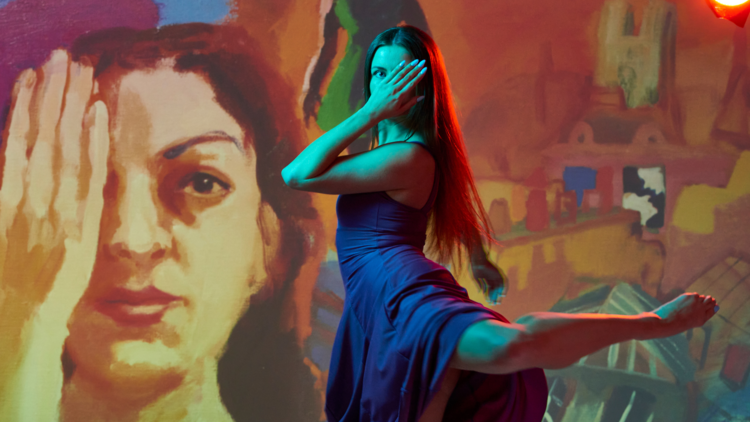Dancer poses with Wendy Sharpe painting and covers eye for Triptico