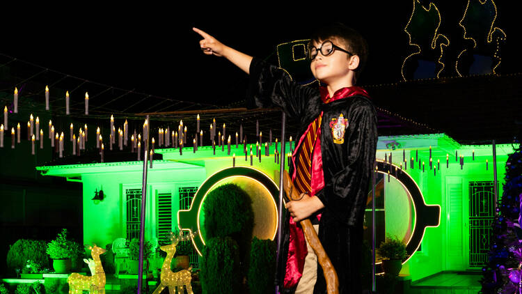 boy dressed as Harry Potter in front of light display
