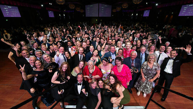 A large crowd posing together at Crown Palladium for the Victorian Tourism Awards.