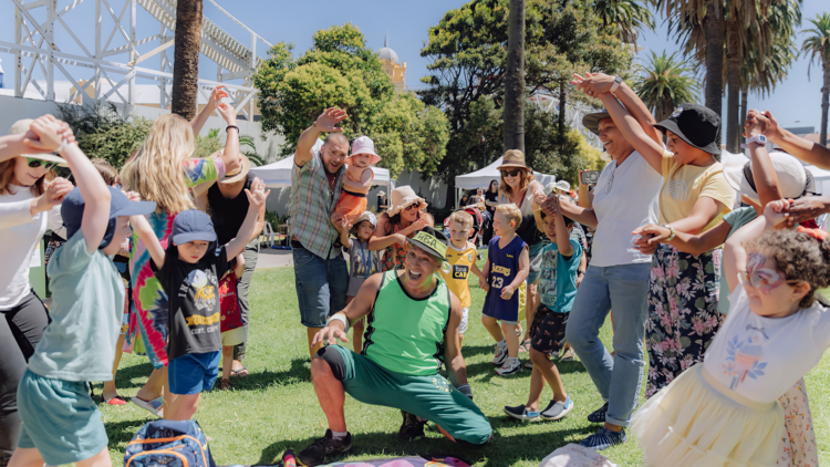 Families watch a performer at St Kilda Festival
