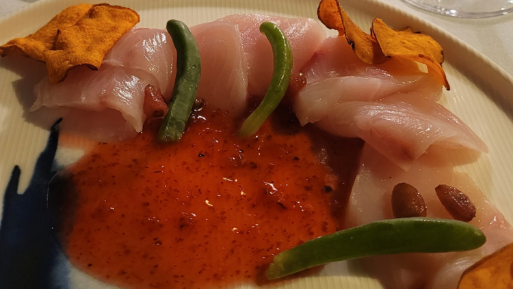 A colourful plate of food including raw fish