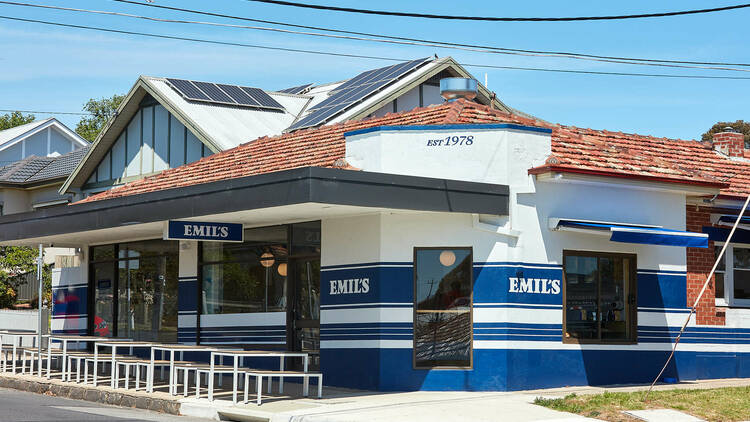 The blue and white exterior of Emil's Café.