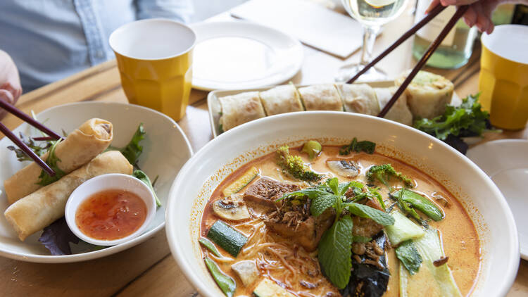 Bowl of laksa and other Malaysian dishes.