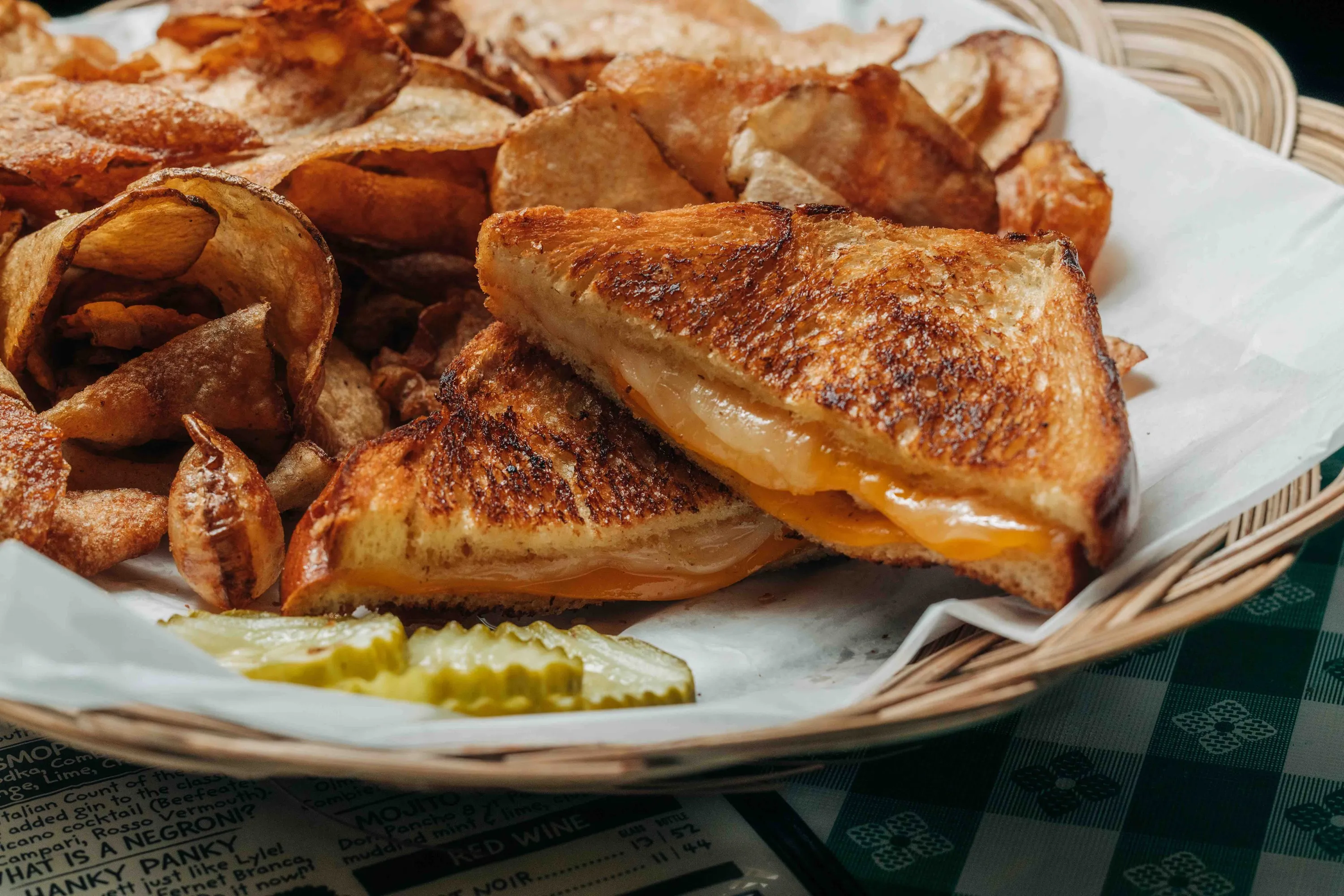 A grilled cheese sandwich and chips