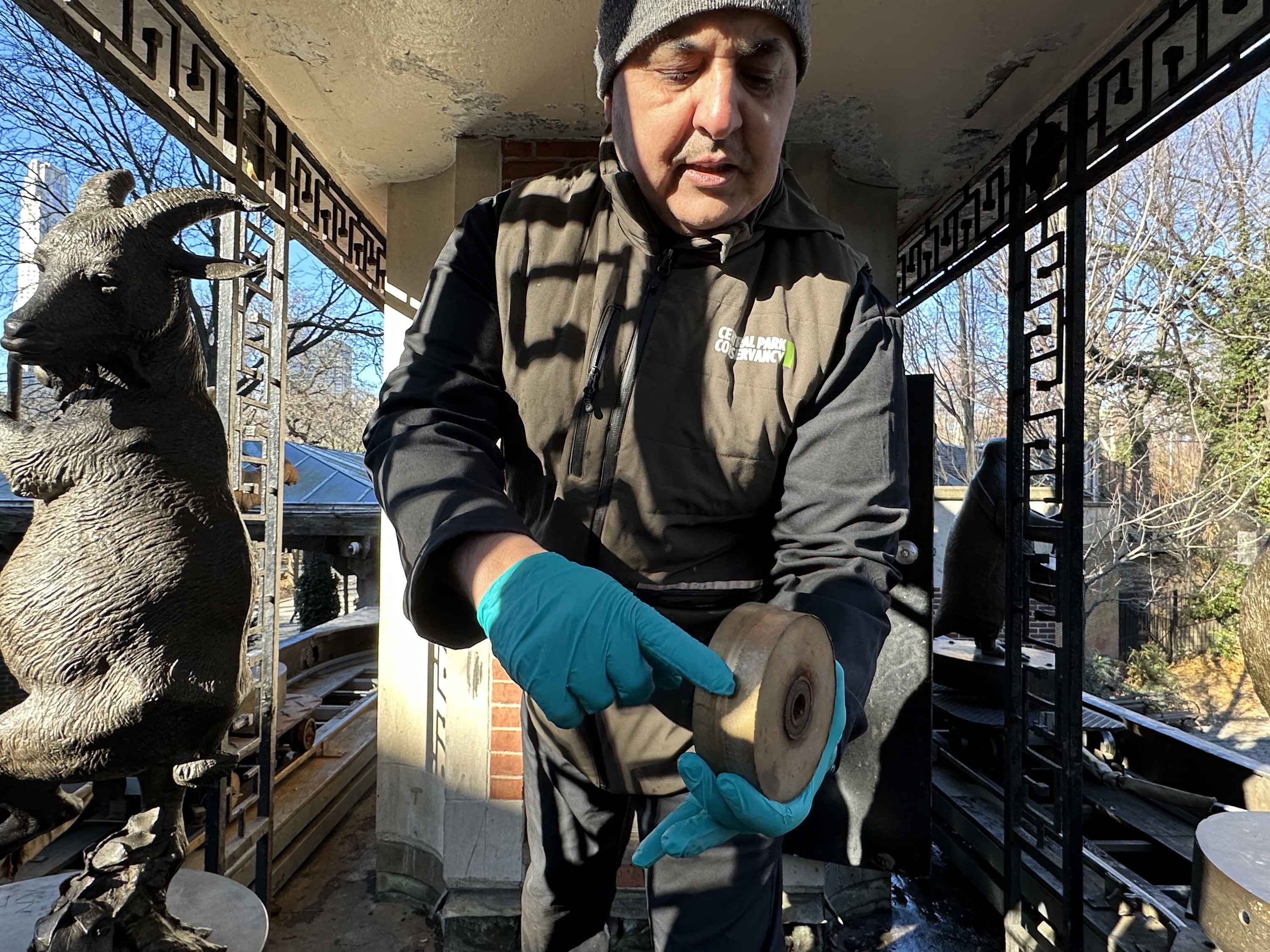 The park's clock foreman shows a wheel from the clock.