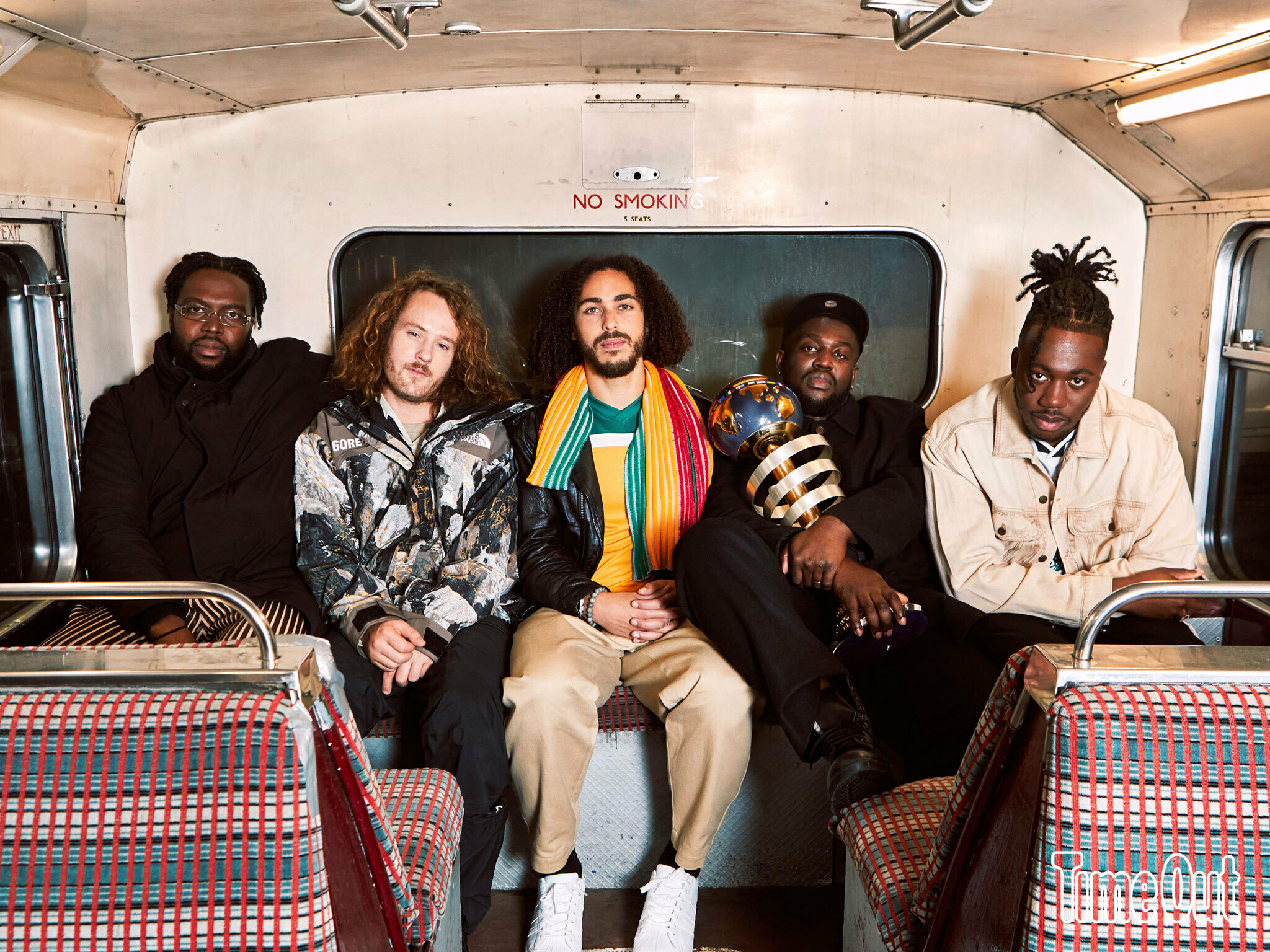 Five men siting inside a bus