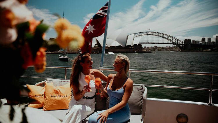 people on superyacht on Sydney harbour drinking Champange