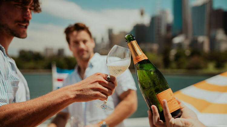people drinking Champagne on superyacht on Sydney harbour