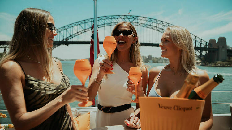 people drinking Champagne on superyacht on Sydney harbour