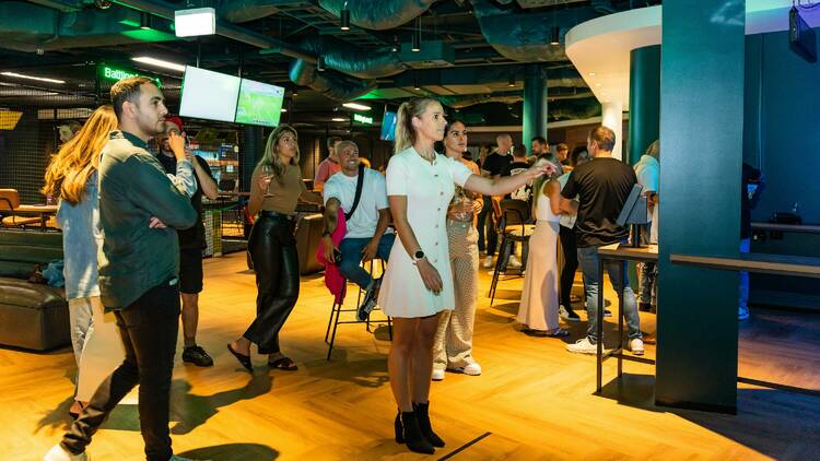 A woman playing darts