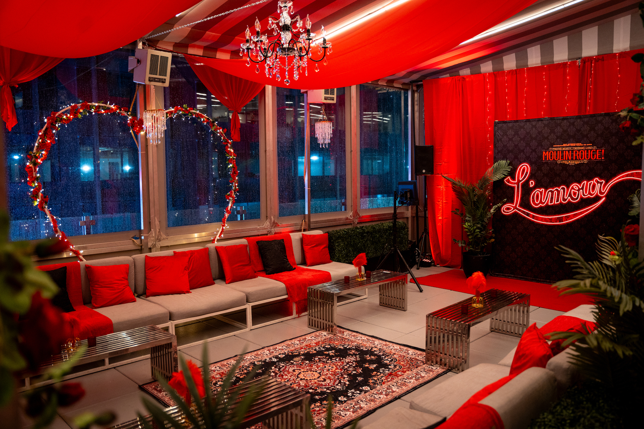 A Moulin Rouge pop-up with red curtains and decor.