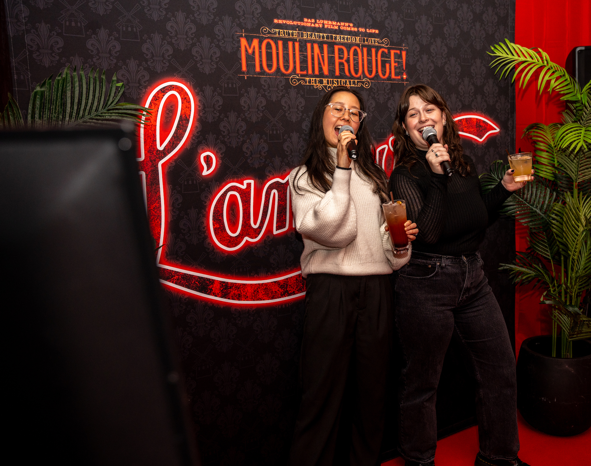 Two women do karaoke at M Social Hotel in Times Square.