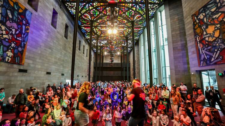 The interior of the NGV Great Hall, filled with children. 