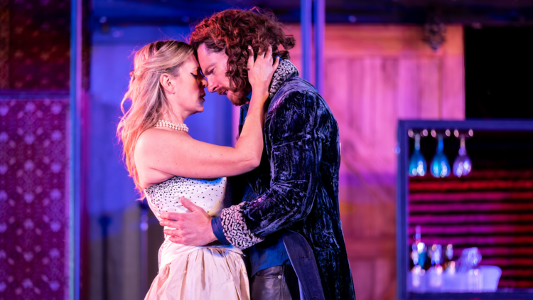 Two actors embrace in Much Ado About Nothing