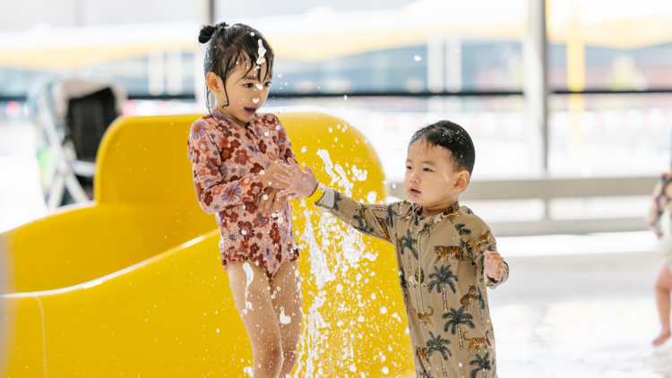 Kids splashing in a pool play area