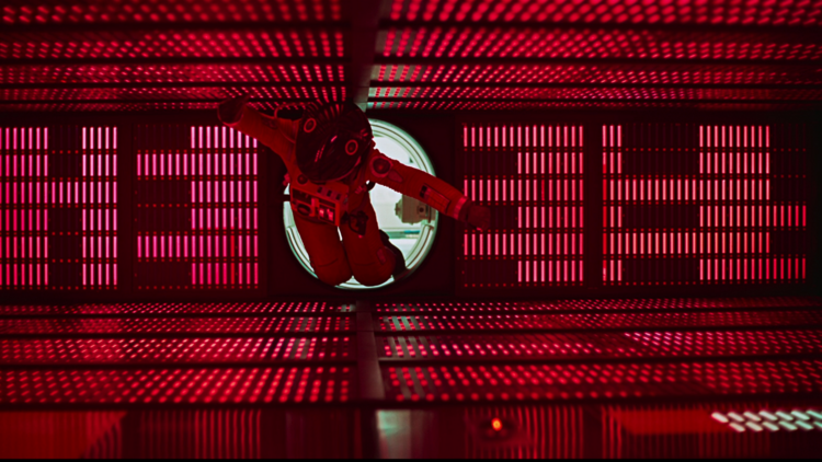 A still from 2001: A Space Odyssey showing an astronaut in a red chamber