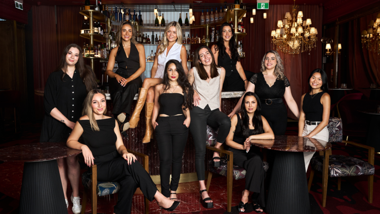 A team of females posing in black outfits