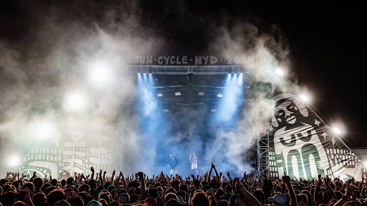 A stage with a crowd clapping. 