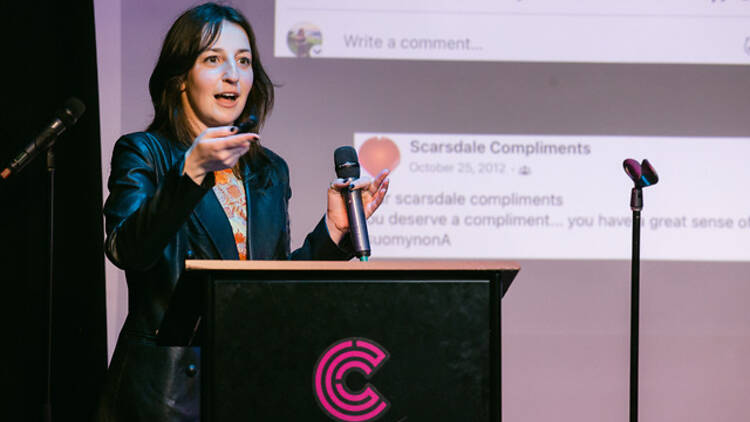 A woman delivers a presentation onstage.