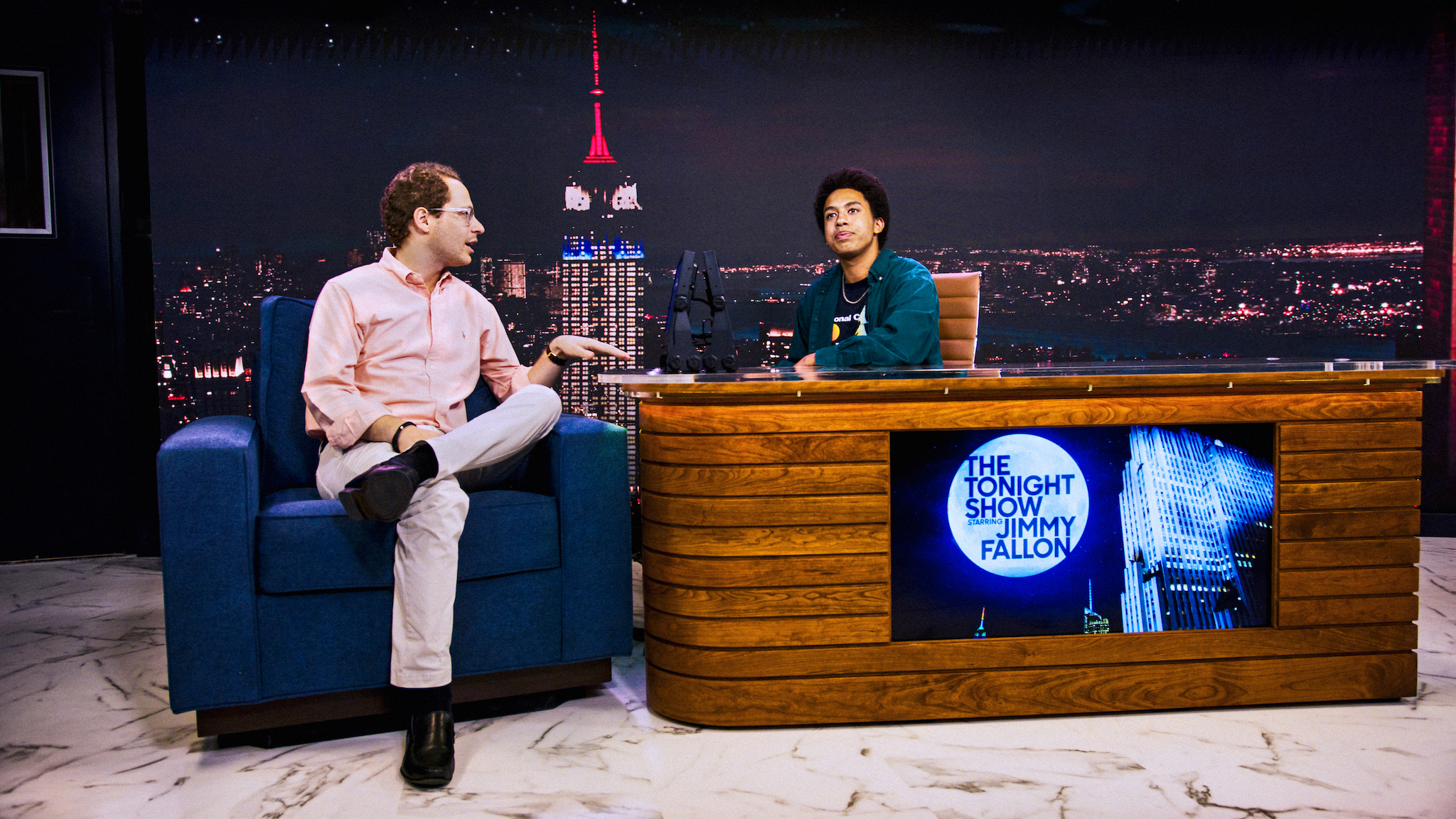 Two people host a pretend late-night show.