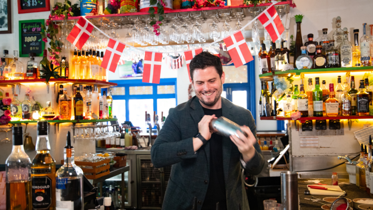 A bartender shaking at Danish cocktail at Slipp Inn