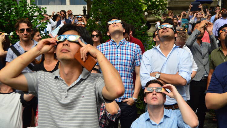 New Yorkers don their solar glasses to view the solar eclipse in Bryant Park in Manhattan.