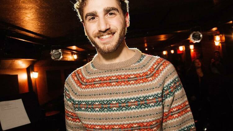  A man in a tan sweater.