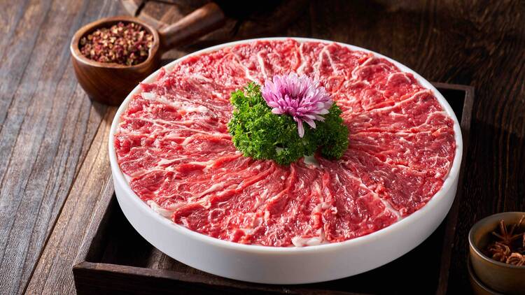 A plate of raw meat for hot pot cooking
