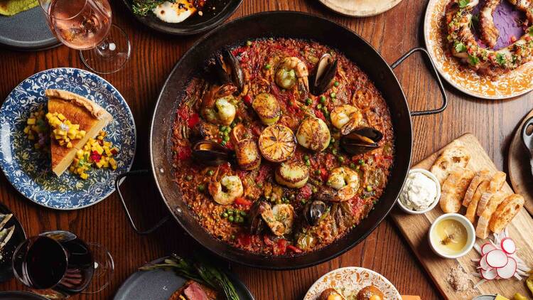 Paella and a variety of dishes on a table