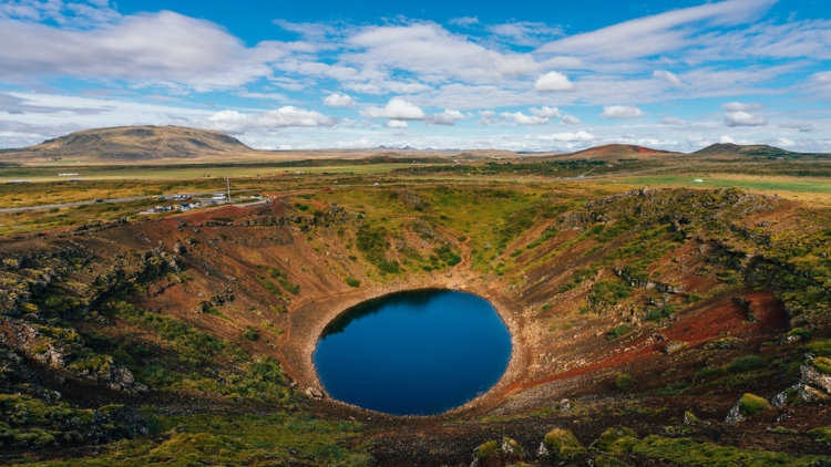 Walk around the rim of Kerið, a colourful volcanic crater